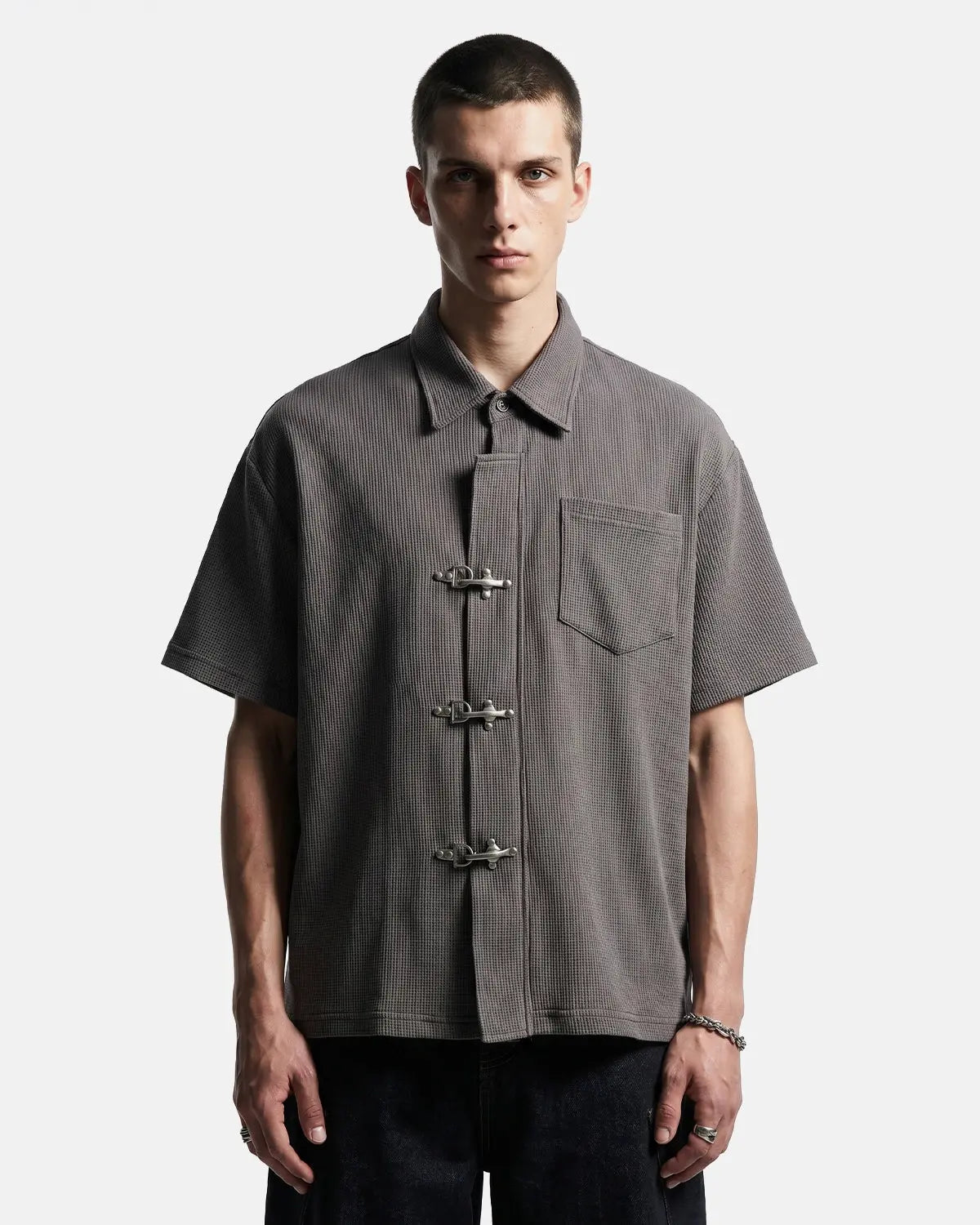 Dark gray Flation Streetwear waffle shirt with metal clasp details, showcasing a casual, textured long-sleeve shirt.