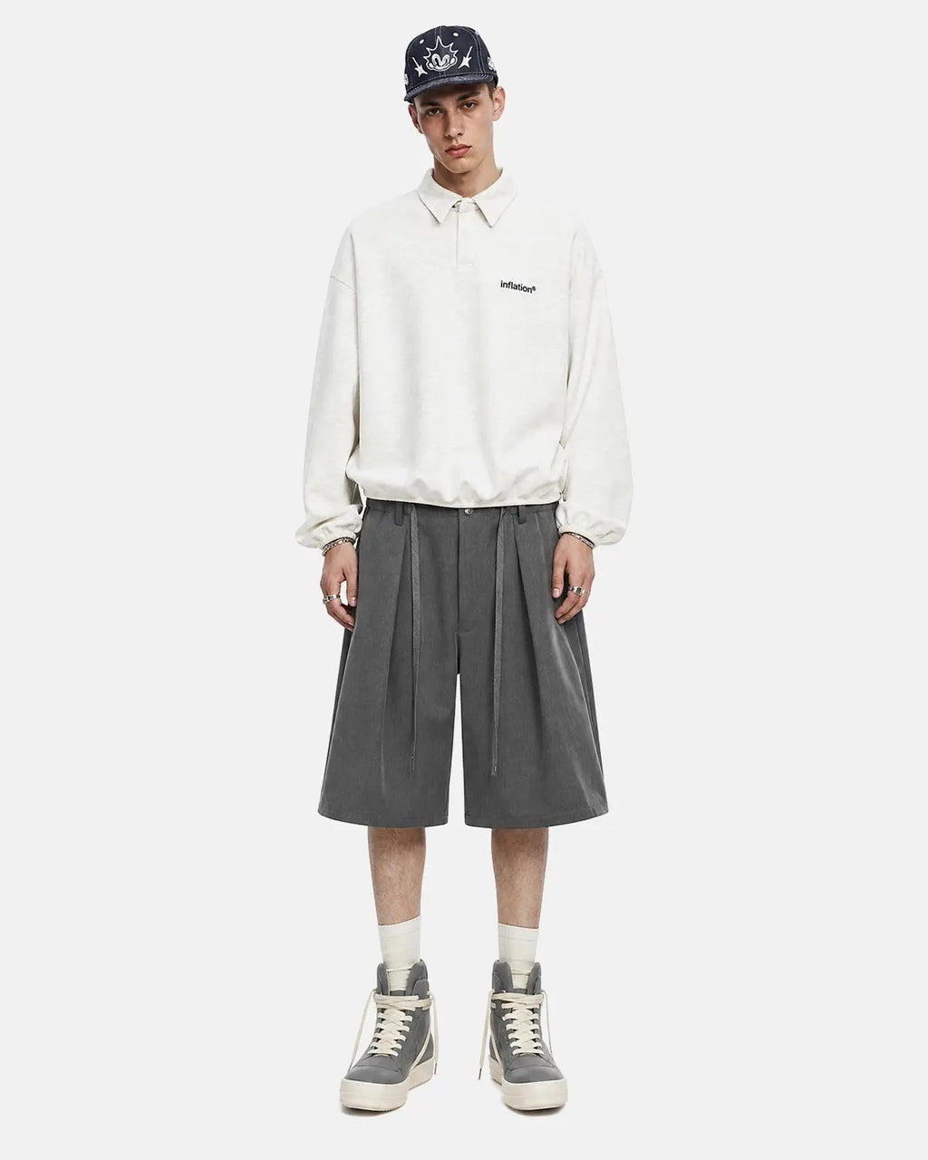 Black drawstring wide-leg tailored shorts by Flation Streetwear, shown on a model with a relaxed fit and casual style.