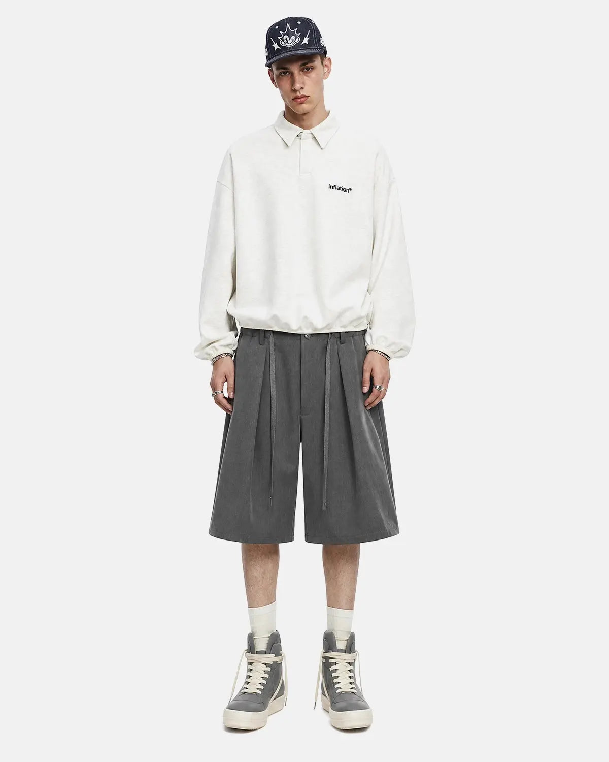 Black drawstring wide-leg tailored shorts by Flation Streetwear, shown on a model with a relaxed fit and casual style.