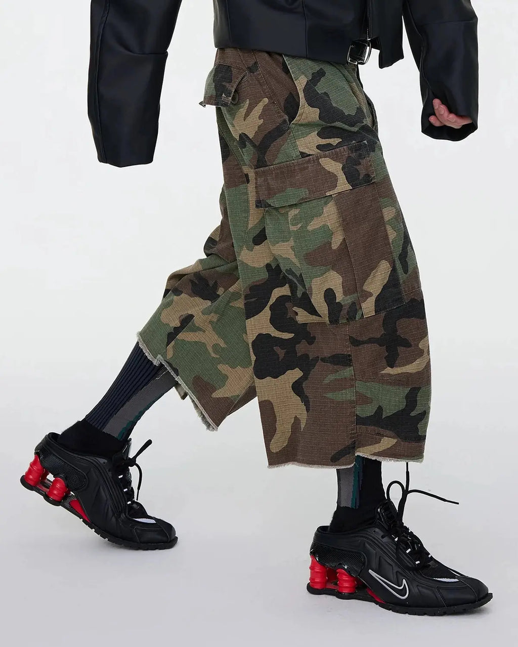 Oversized camo cargo longline shorts by Flation Streetwear, featuring baggy fit and multiple cargo pockets on durable fabric.