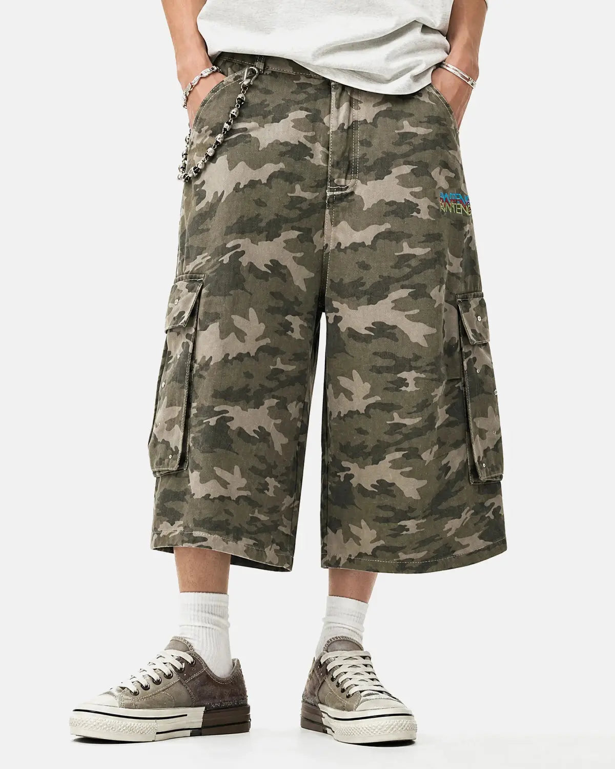 Embroidered camo cargo longline shorts by Flation Streetwear, featuring a relaxed fit and detailed embroidery on the fabric.