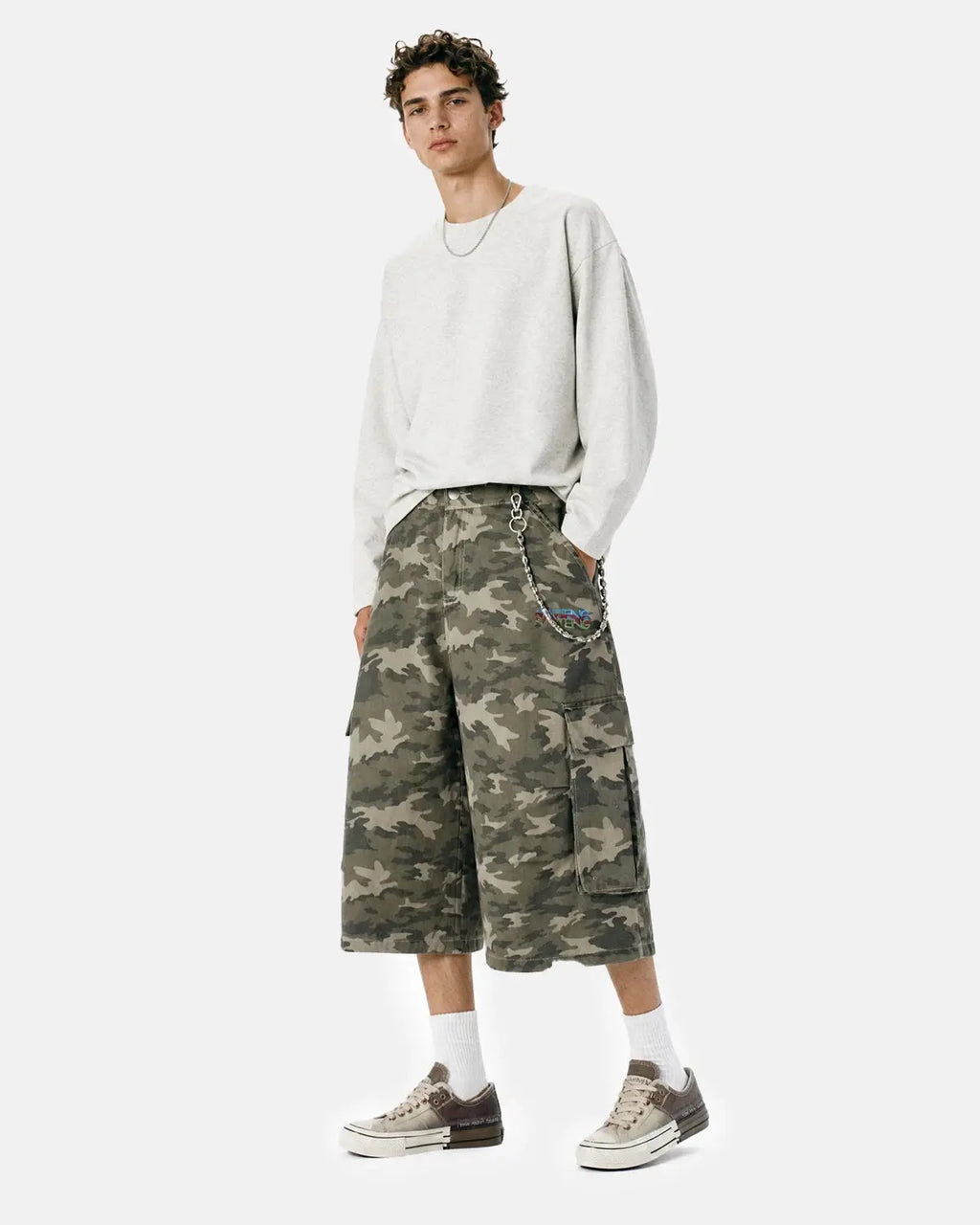 Embroidered camo cargo longline shorts by Flation Streetwear, featuring a relaxed fit and detailed embroidery on the fabric.