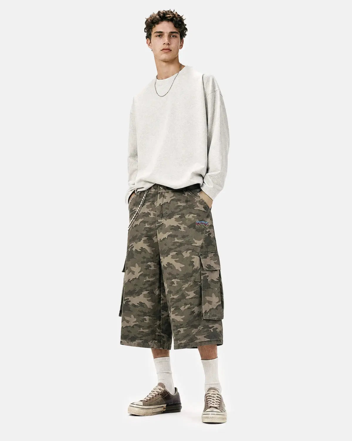 Embroidered camo cargo longline shorts by Flation Streetwear featuring durable fabric and detailed embroidery in a stylish camouflage pattern.