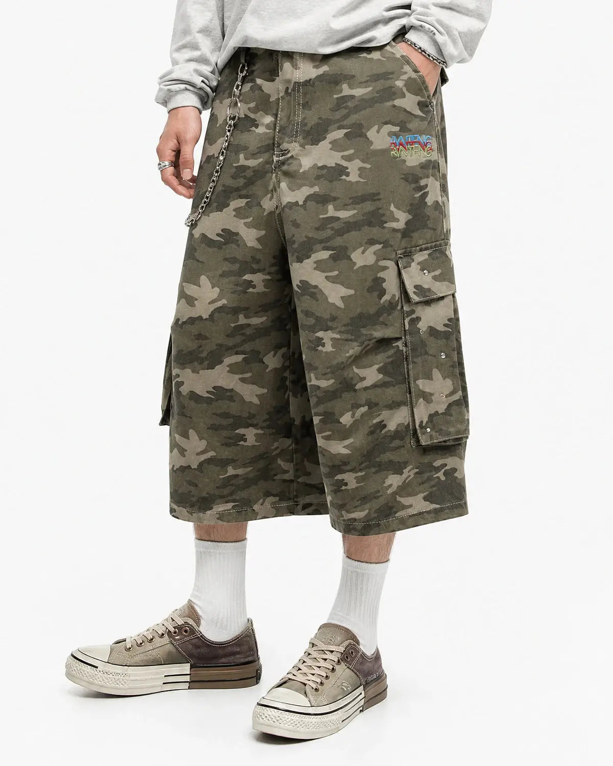 Embroidered camo cargo longline shorts by Flation Streetwear with multiple pockets and streetwear style, shown on model.