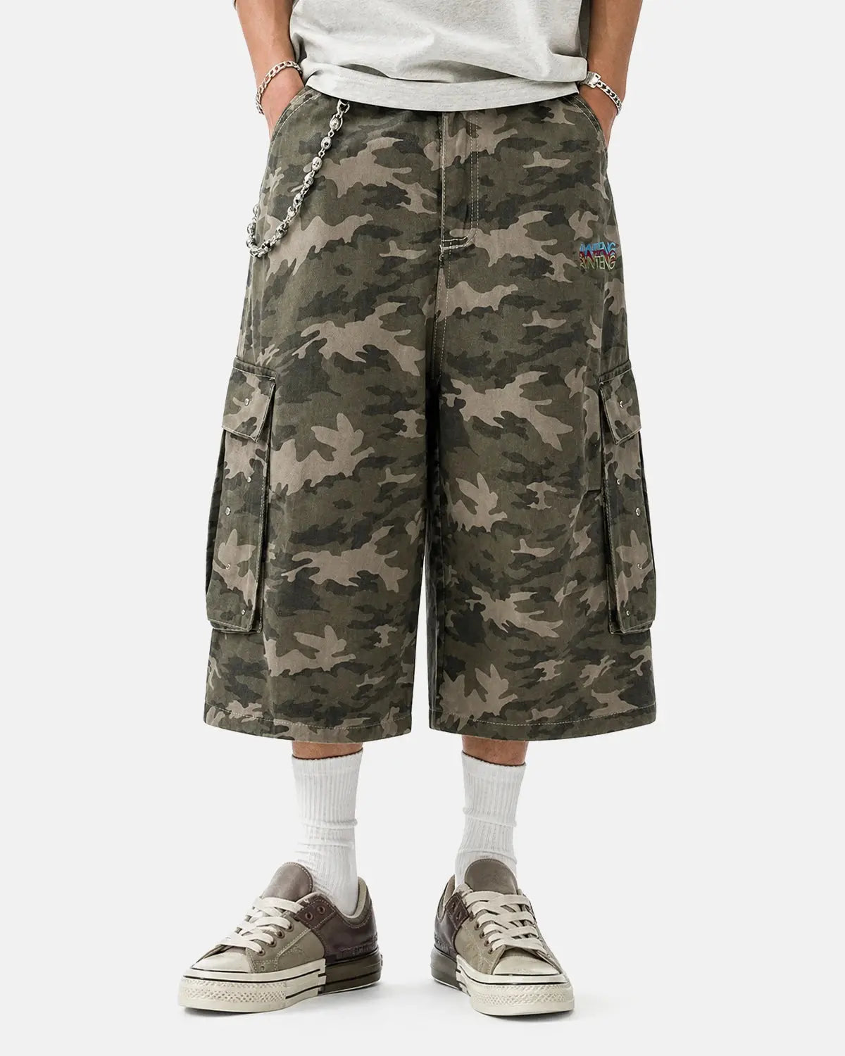 Embroidered camo cargo longline shorts by Flation Streetwear featuring detailed embroidery and a relaxed fit.