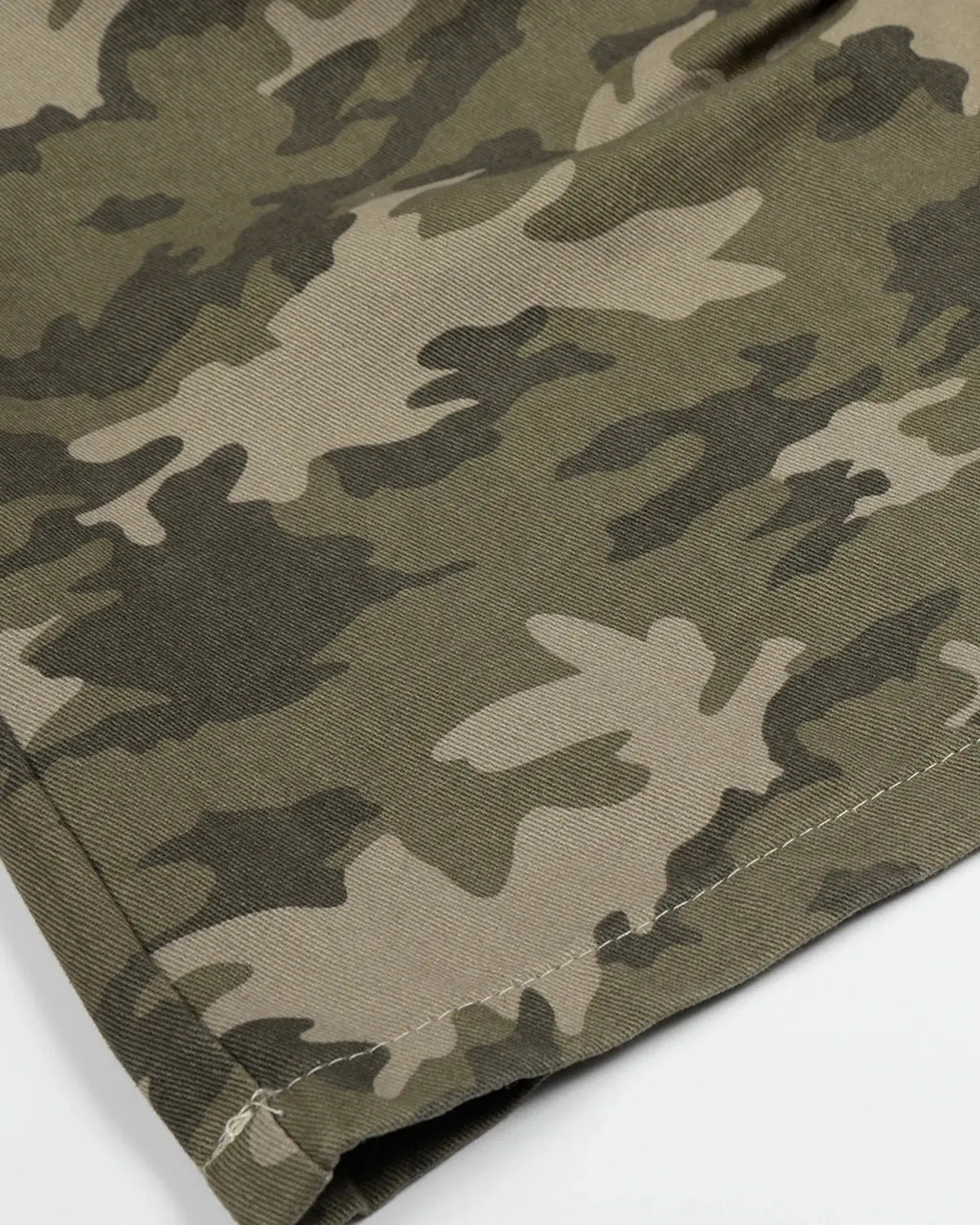 Embroidered camo cargo longline shorts by Flation Streetwear, featuring a relaxed fit with side pockets and detailed embroidery.