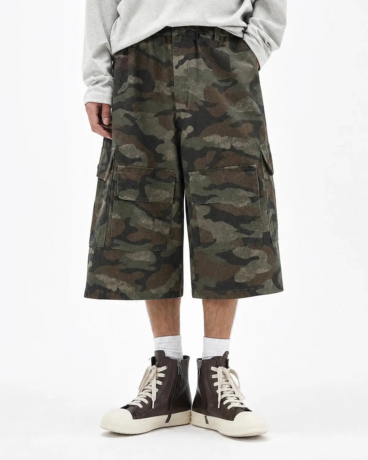 Grey camo Flation utility longline shorts with multiple pockets and relaxed fit, styled for streetwear fashion.