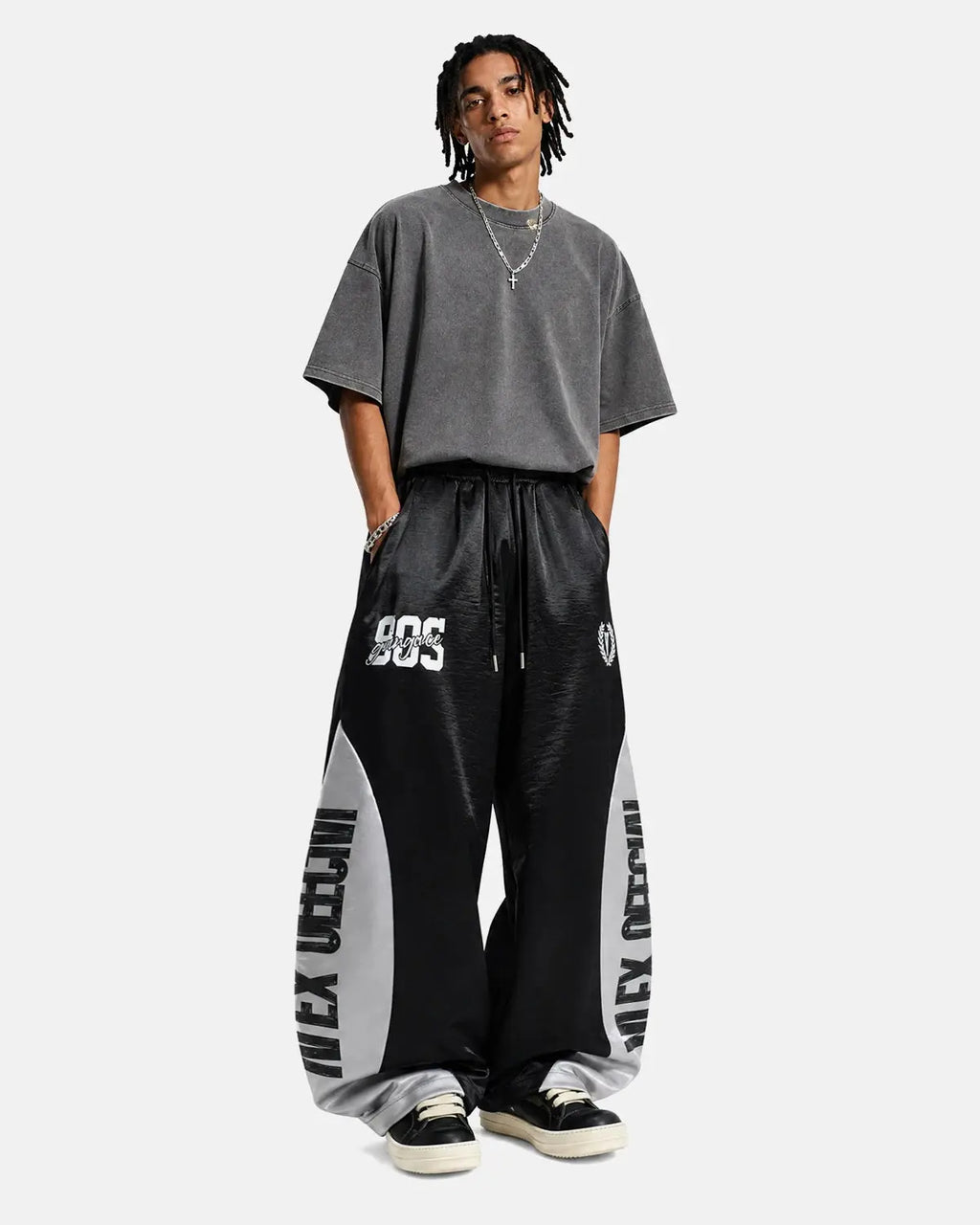 Black glossy contrast barrel sweatpant by Flation Streetwear, featuring a relaxed fit and stylish design.
