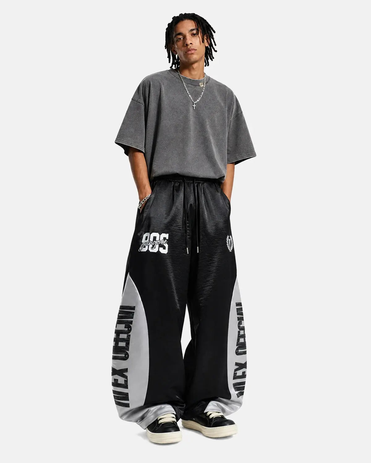 Black glossy contrast barrel sweatpant by Flation Streetwear, featuring a relaxed fit and stylish design.