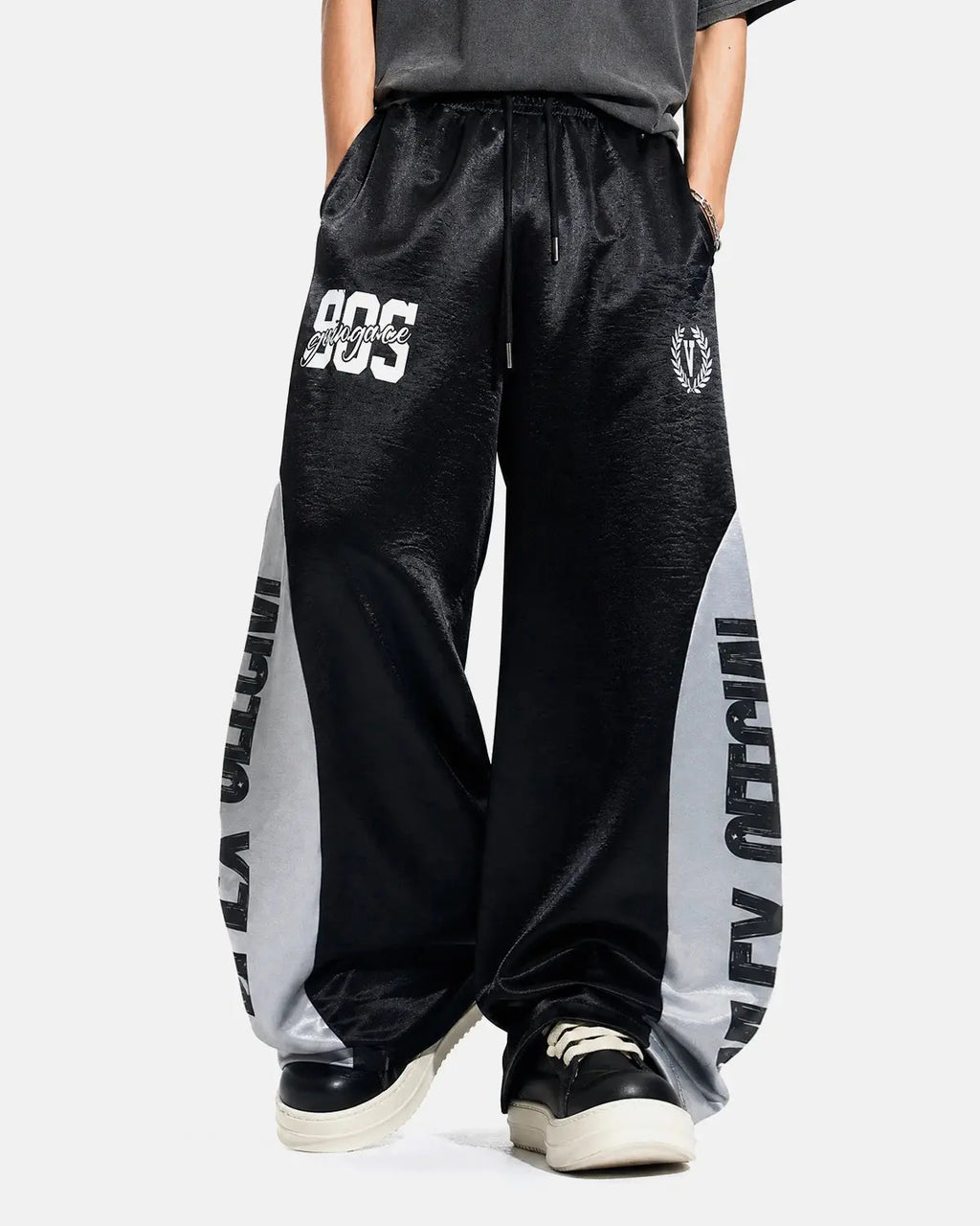Black glossy contrast barrel sweatpant by Flation Streetwear, featuring a relaxed fit and stylish design.