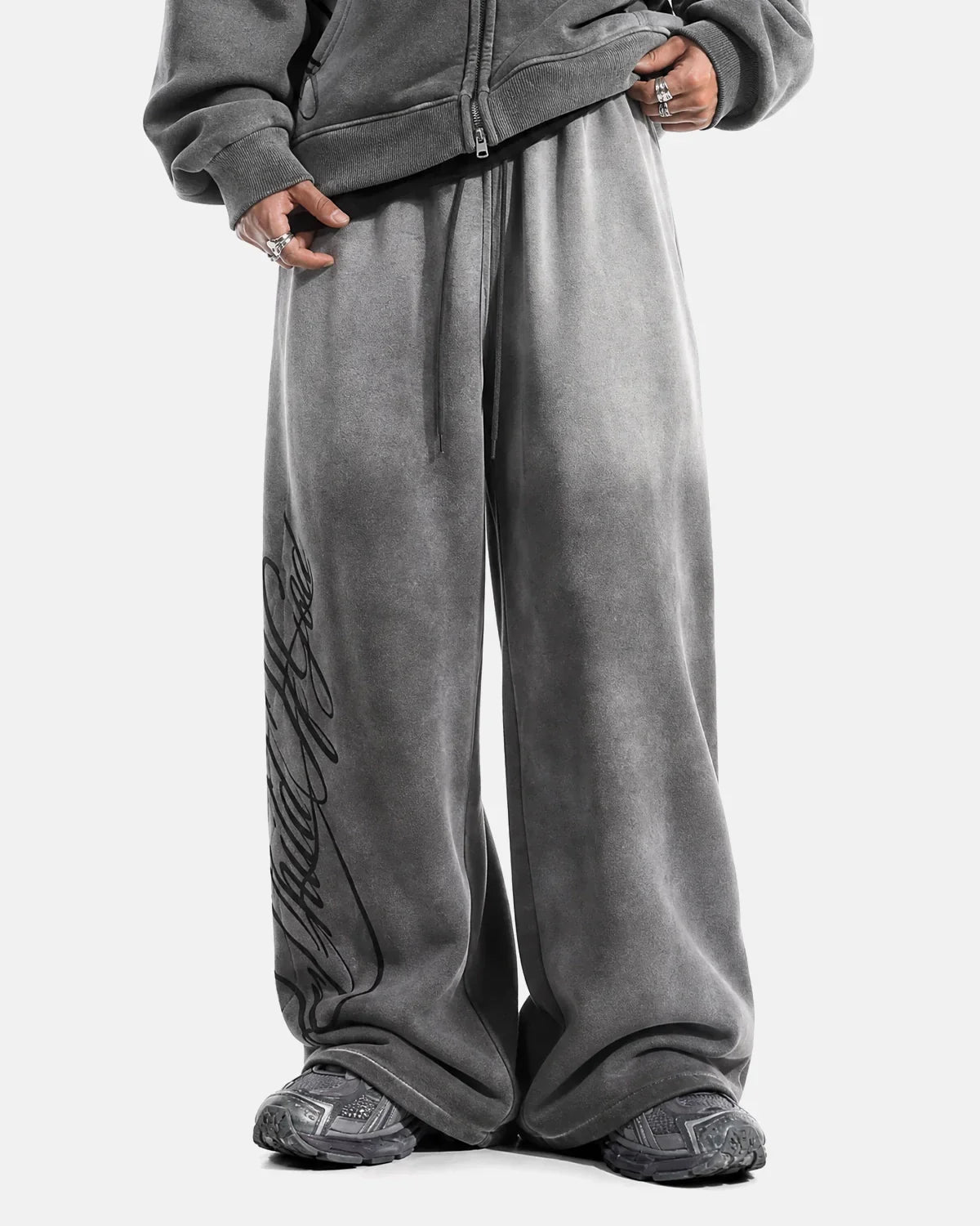 Dark grey acid washed Flation Streetwear sweatpants with a relaxed fit, featuring an elastic waistband and tapered cuffs.
