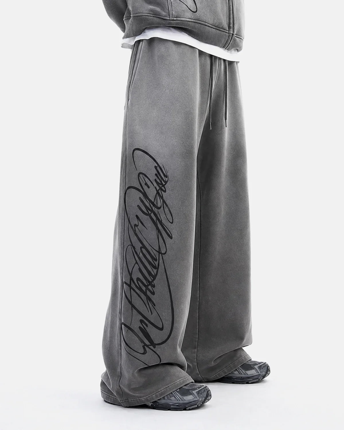 Dark grey acid washed Flation Streetwear sweatpants with relaxed fit and elastic waistband, casual and comfortable for everyday wear.