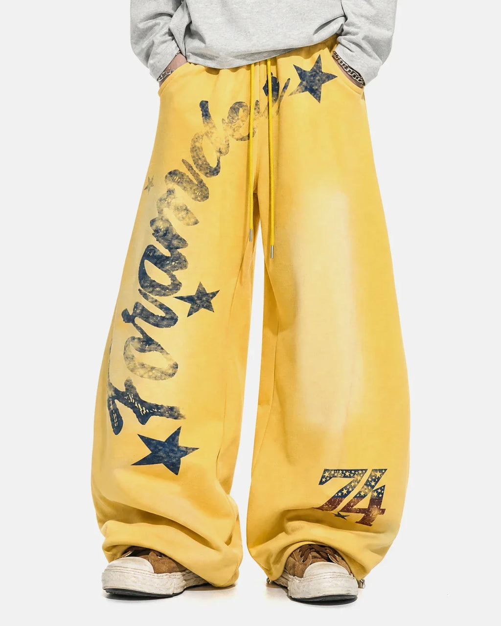 Yellow star graphic barrel sweatpants by Flation Streetwear, featuring a relaxed fit and casual streetwear style.