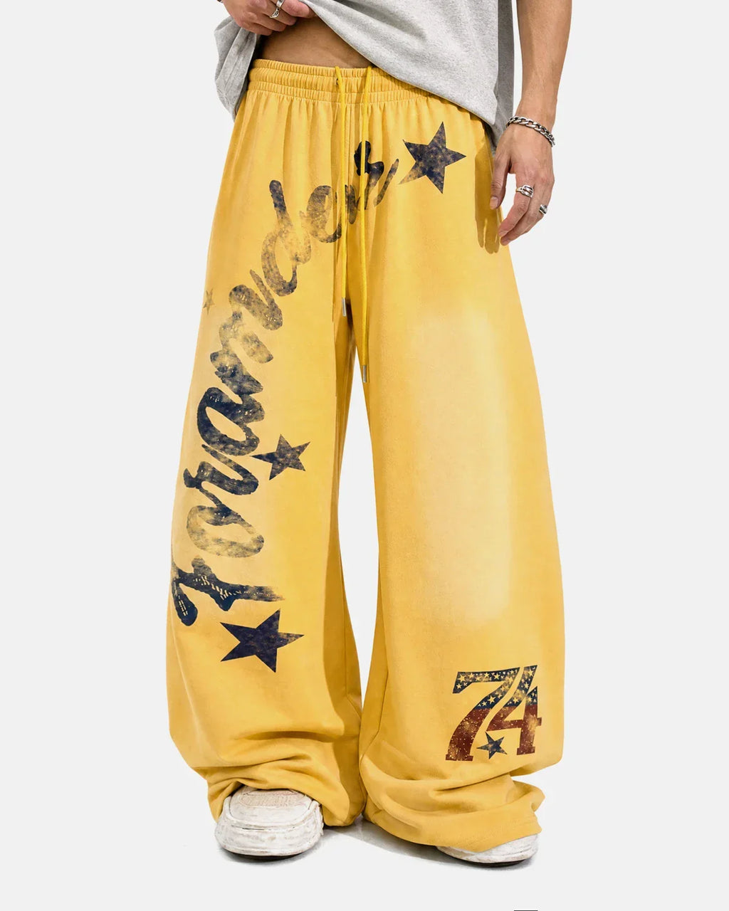 Yellow star graphic barrel sweatpants from Flation Streetwear, featuring a relaxed fit and comfortable design.