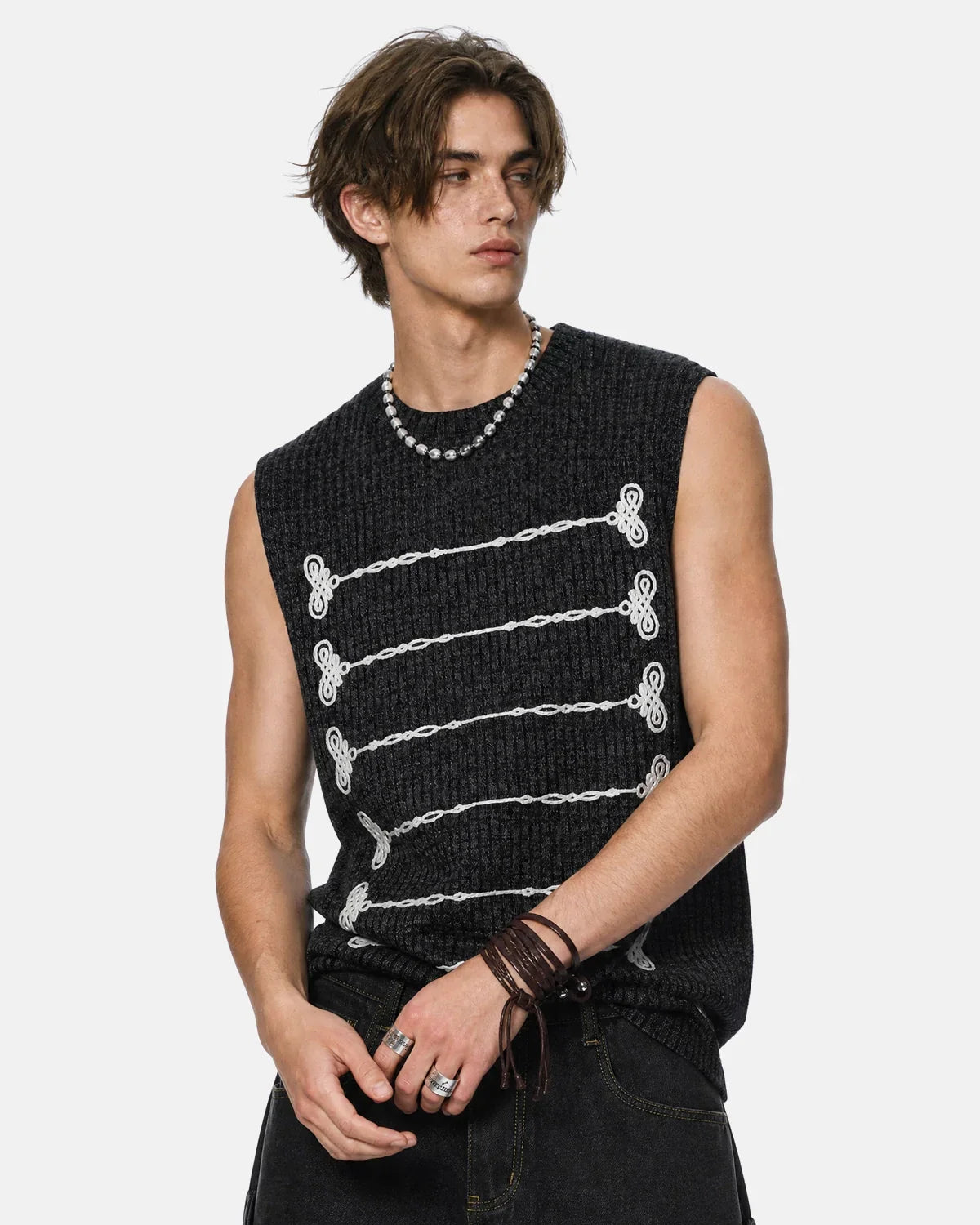 Black embroidered knit tank top by Flation Streetwear, featuring detailed stitching and a relaxed fit, perfect for casual styling.