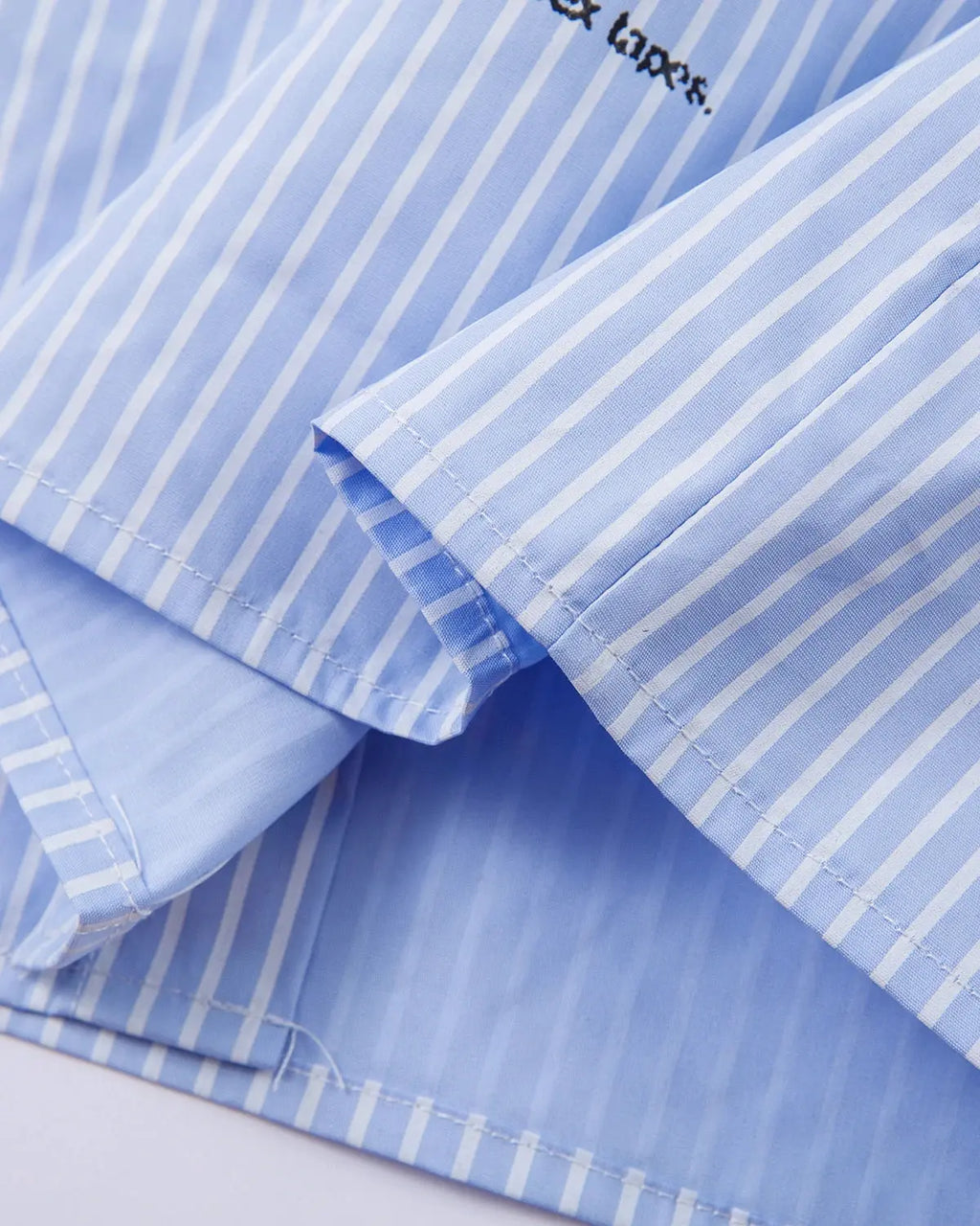 Blue striped graphic layered long-sleeve T-shirt from Flation Streetwear with a casual, modern design.