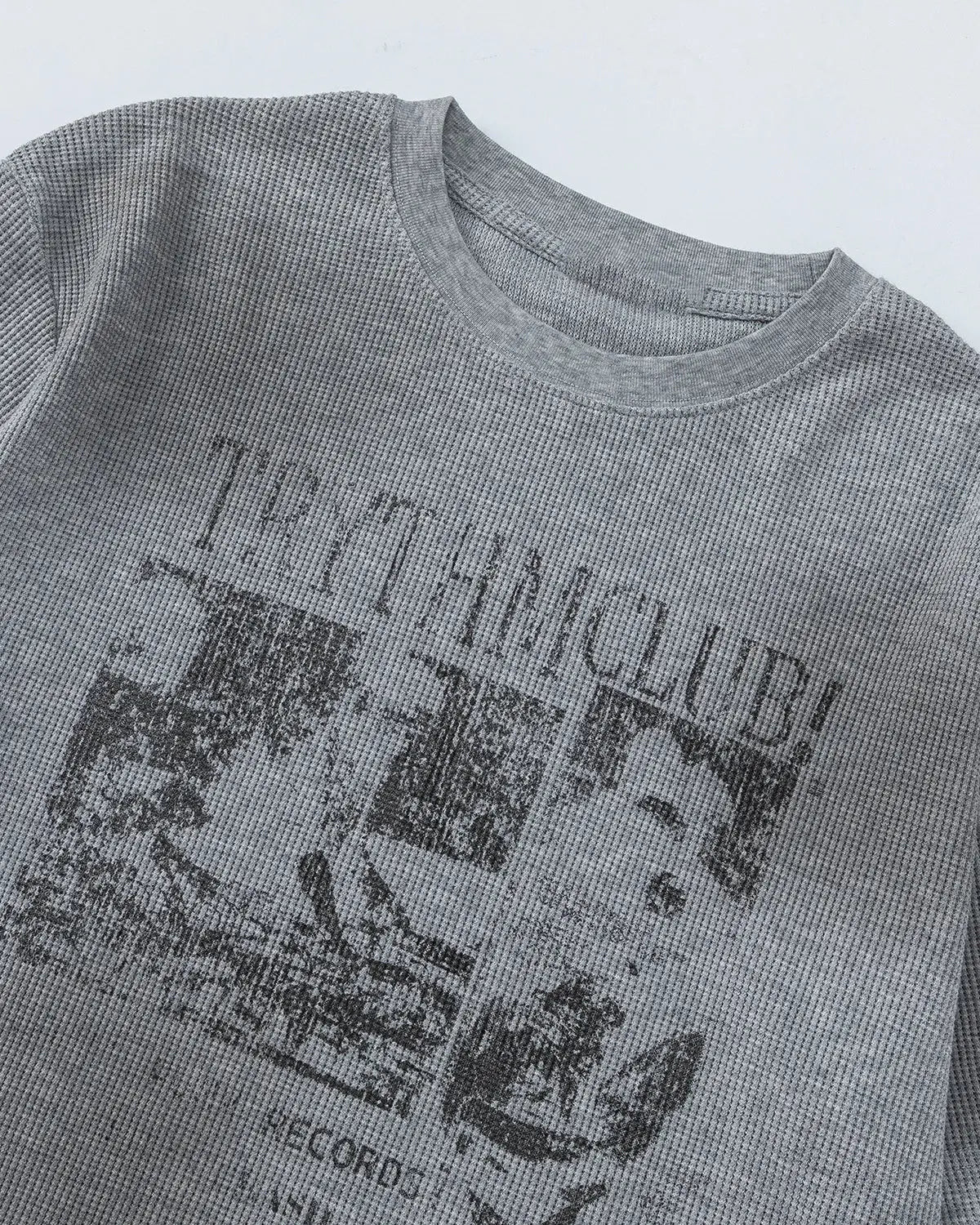 Gray Flation streetwear T-shirt featuring a distressed graphic waffle design on the front.