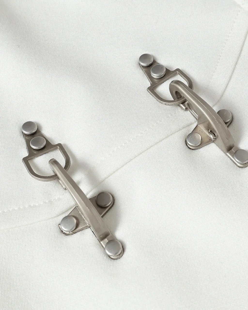 White cotton T-shirt by Flation with metal buckle detail and streetwear style, featuring a relaxed fit and casual design.