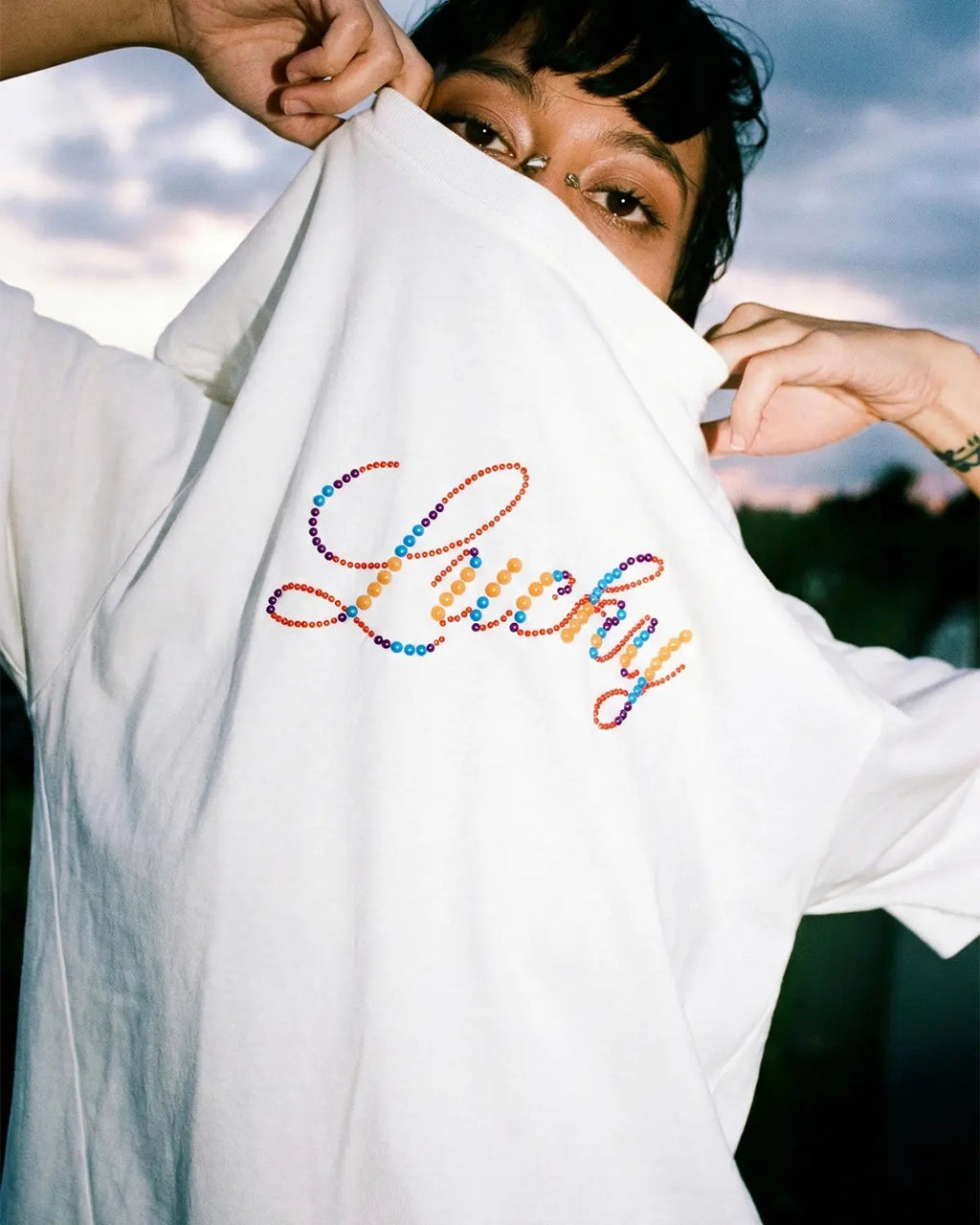 Flation Rhinestone Lucky graphic oversized T-shirt featuring bold print and sparkling rhinestone details on soft streetwear fabric.