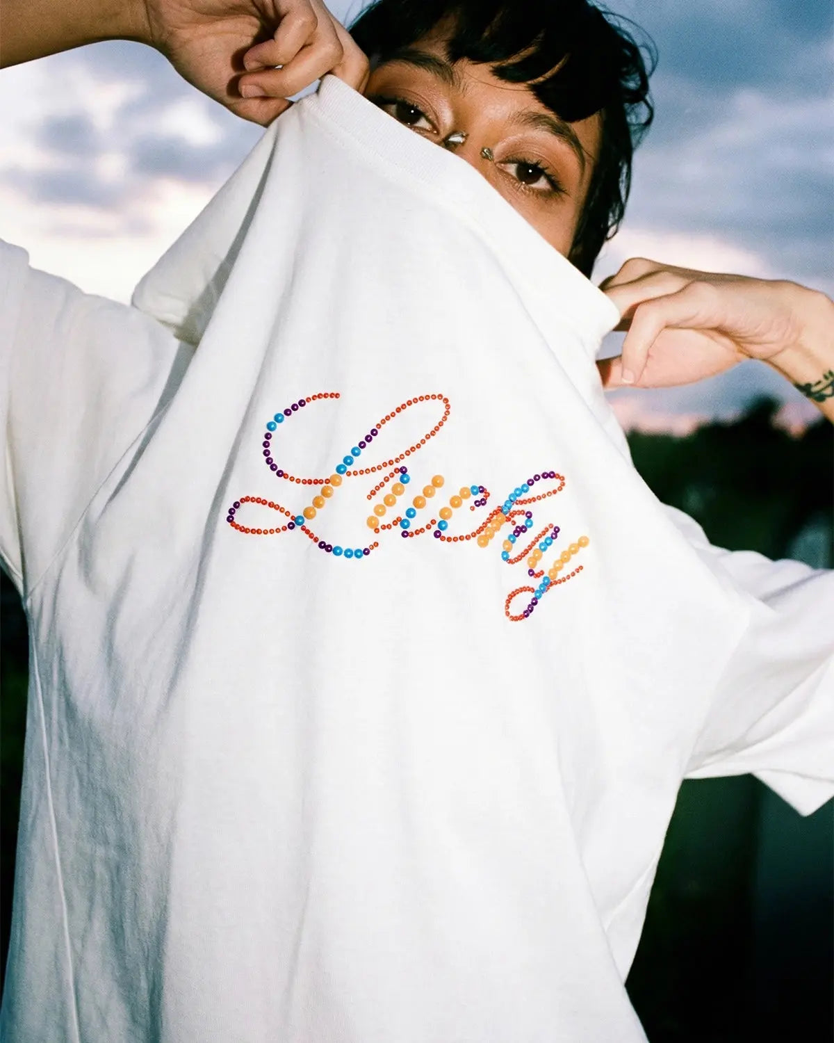 Flation Rhinestone Lucky graphic oversized T-shirt featuring bold print and sparkling rhinestone details on soft streetwear fabric.