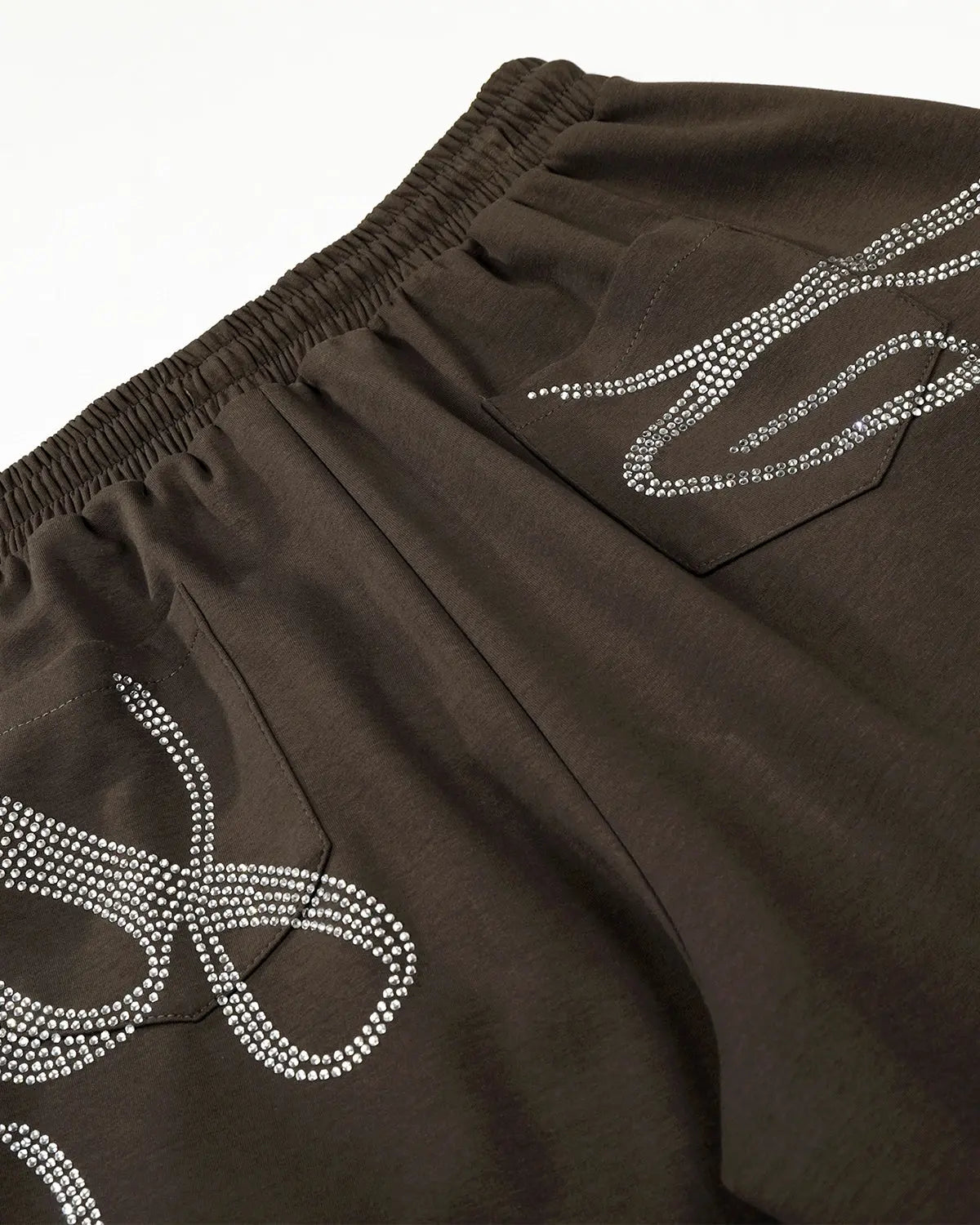White rhinestone baggy joggers by Flation Streetwear featuring sparkling rhinestone accents and relaxed, oversized fit.