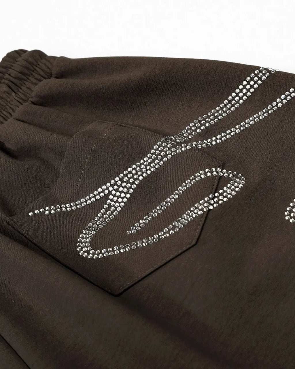 White rhinestone baggy joggers by Flation Streetwear featuring sparkling rhinestone details and a relaxed, oversized fit.