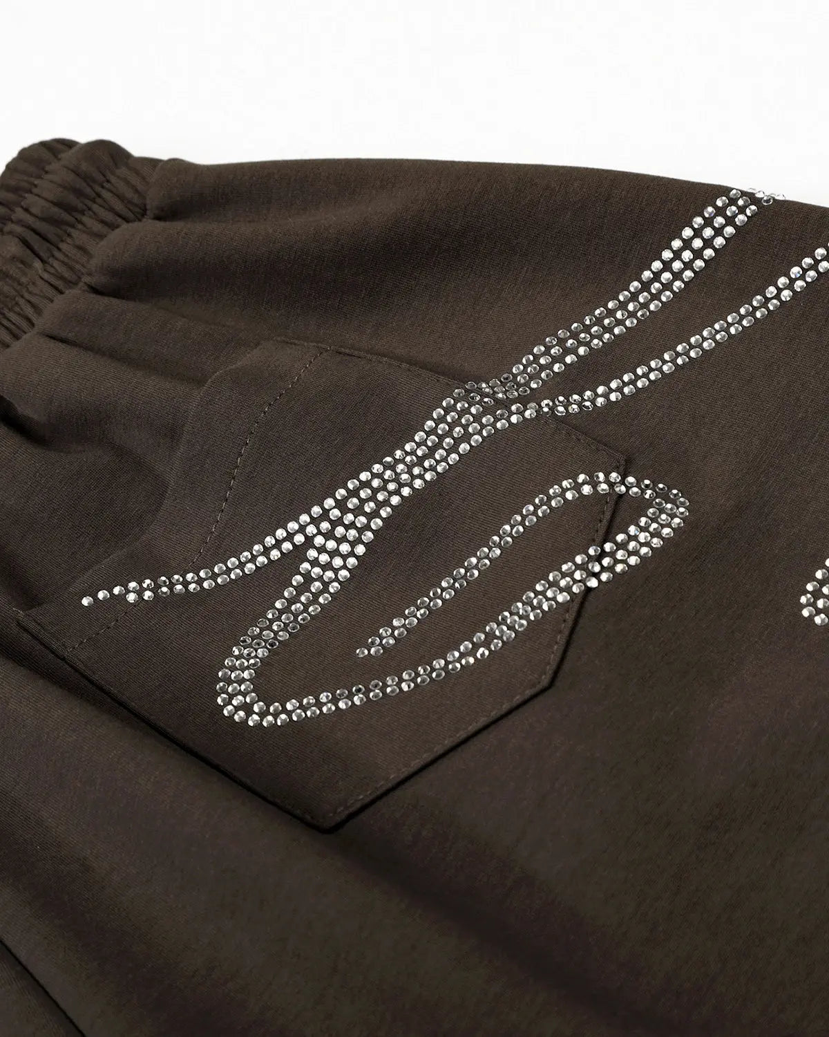 White rhinestone baggy joggers by Flation Streetwear featuring sparkling rhinestone details and a relaxed, oversized fit.
