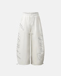 White rhinestone baggy joggers from Flation Streetwear featuring rhinestone embellishments and a relaxed fit for casual style.